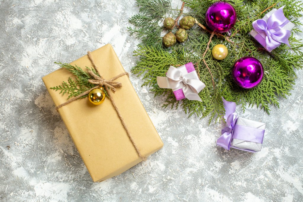 top-view-christmas-gift-pine-tree-branches-xmas-tree-toys-on-grey-background.jpg